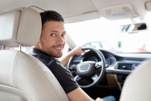 Smiling man driving a car