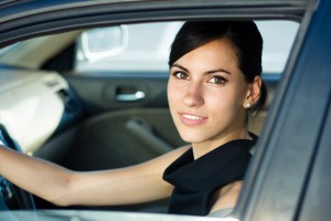 Woman inside car smiling