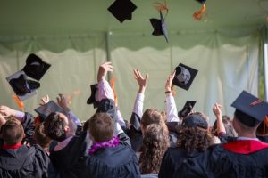 College graduates throwing caps. Title Loans Express is awarding $1,000 scholarships to 5 students!