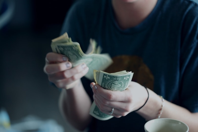 A person sitting at a table with a cup of coffee